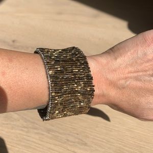 Bronze beaded adjustable bracket.